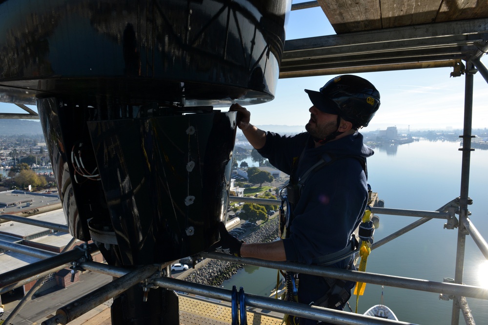 Coast Guard electronics technicians repair critical equipment aboard National Security Cutter while 147’ feet above sea level