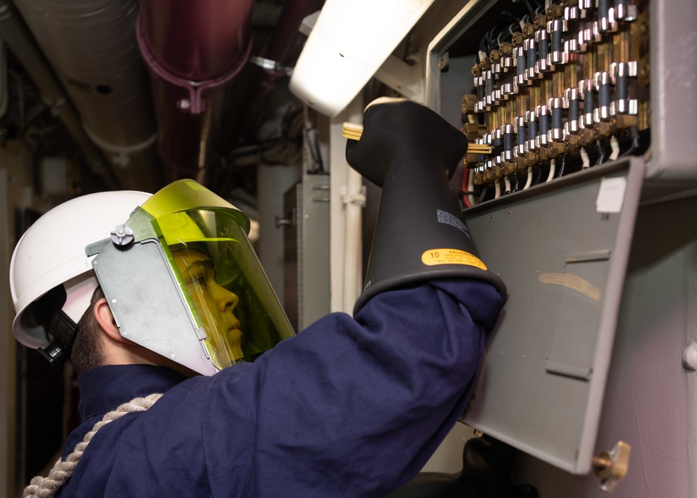 U.S. Sailor replaces a fuse