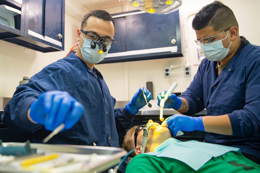 U.S. Sailors conduct dental procedure