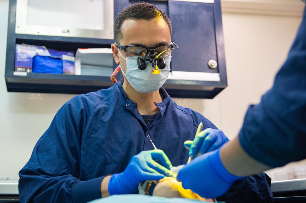 U.S. Sailor conducts dental procedure