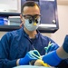 U.S. Sailor conducts dental procedure