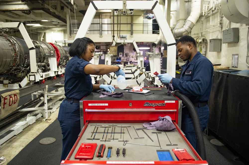 U.S. Sailors clean tools