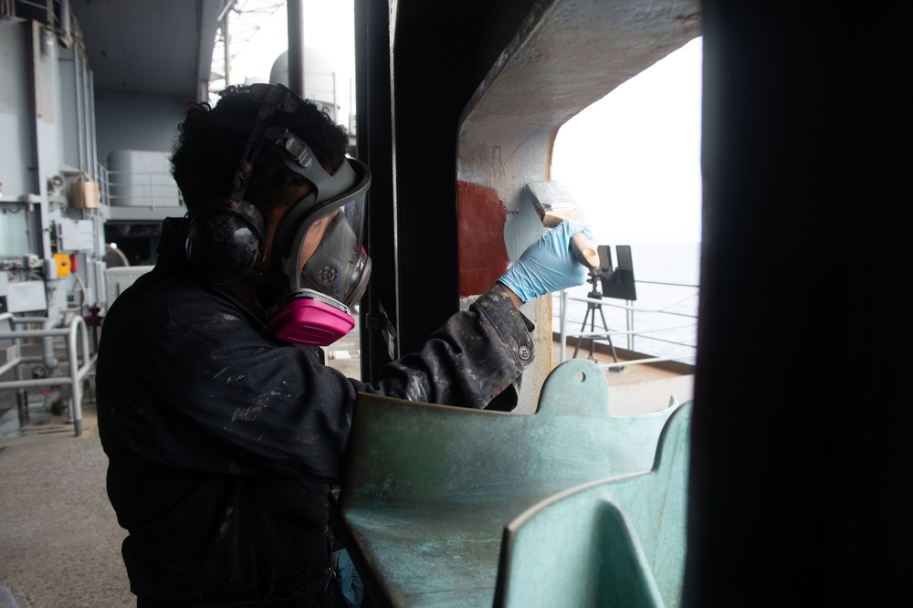 U.S. Sailor paints an angle iron