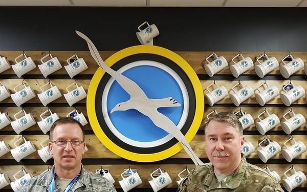 Master Sgts. Pat Ryan and Robert Segrin with Capt. Paul L. Utz's personalized stein