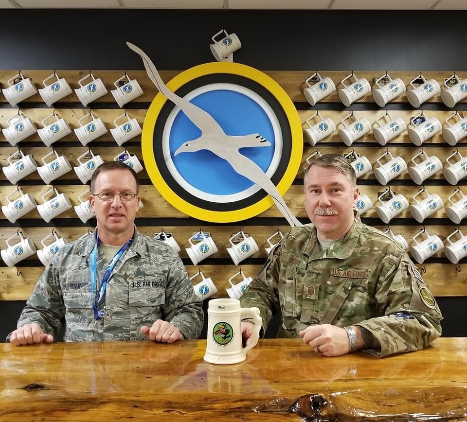 Master Sgts. Pat Ryan and Robert Segrin with Capt. Paul L. Utz's personalized stein