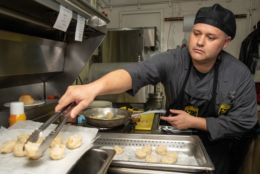 U.S. Sailor prepares food