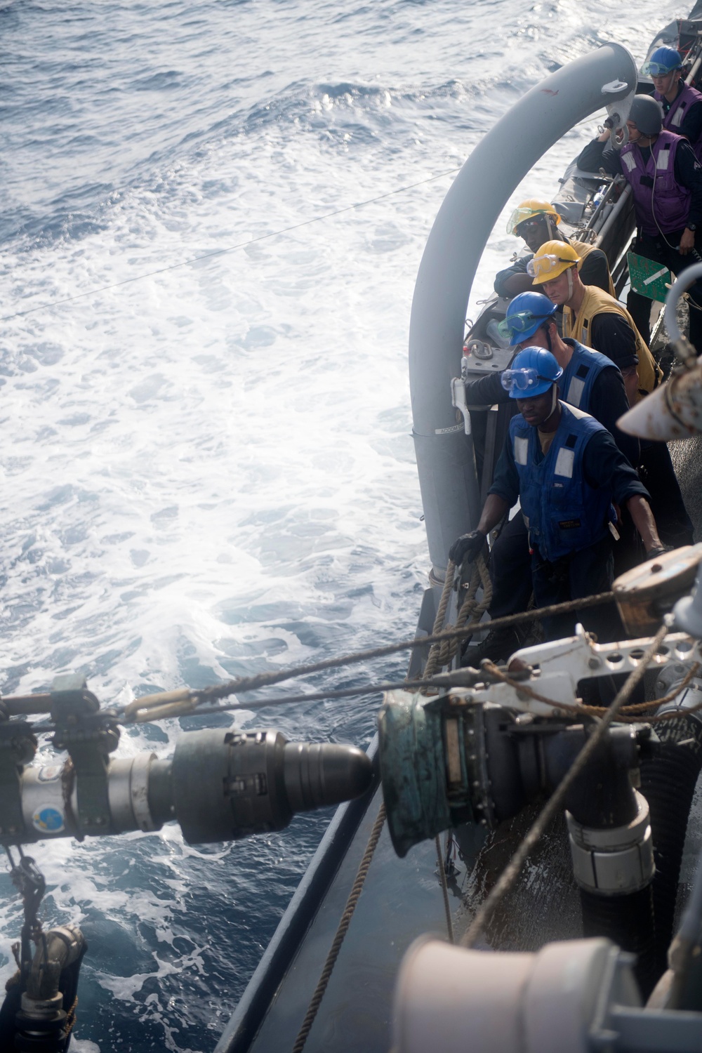 U.S. Sailors observe a probe assembly from the fleet replenishment oiler USNS Guadalupe