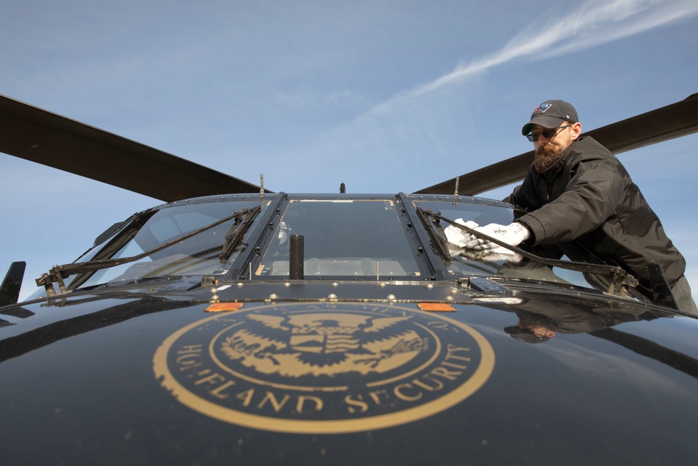Grounds Crewman Cleans the Windshield of a  UH-60 Black Hawk in Support for Super Bowl LIII