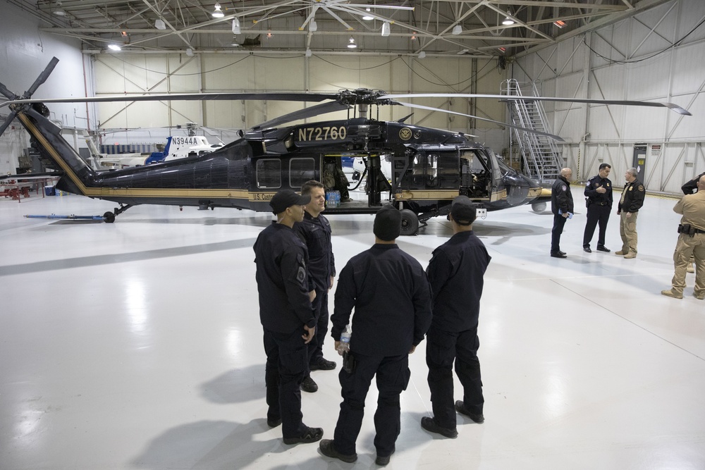 SRT Members Gather Near an AMO UH-60 Helicopter