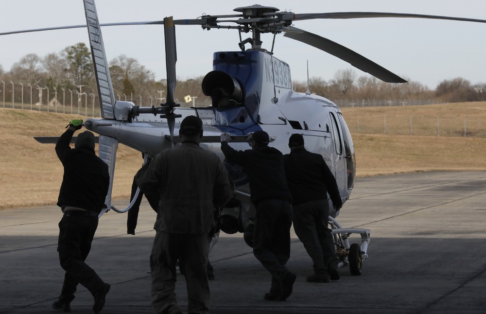 CBP AMO Ground Workers Push a AS350 A-Star Helicopter