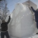 Sailors remove ice buildup from sculpture