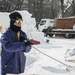 Chief removes snow off sculpture