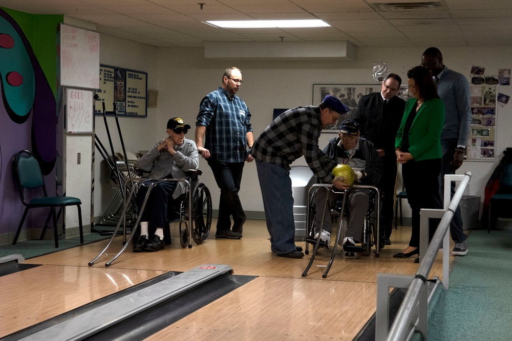 Michigan Adjutant General, Governor and Lt. Governor tour bowling alley at veterans home in Grand Rapids