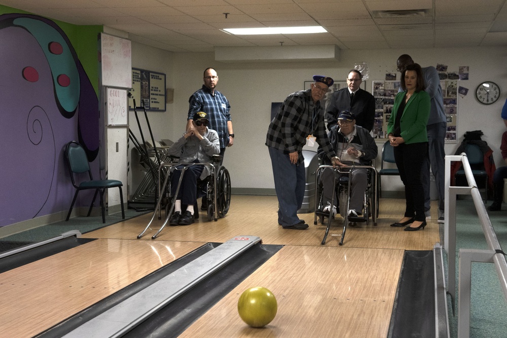 Michigan Adjutant General, Governor and Lt. Governor tour bowling alley at veterans home in Grand Rapids