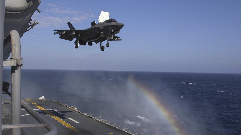 F-35B Lightning II fighters conduct flight operations at sea with external pylons