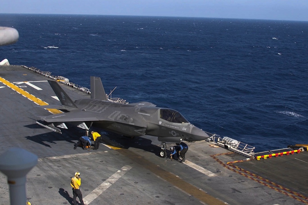 F-35B Lightning II fighters conduct flight operations at sea with external pylons