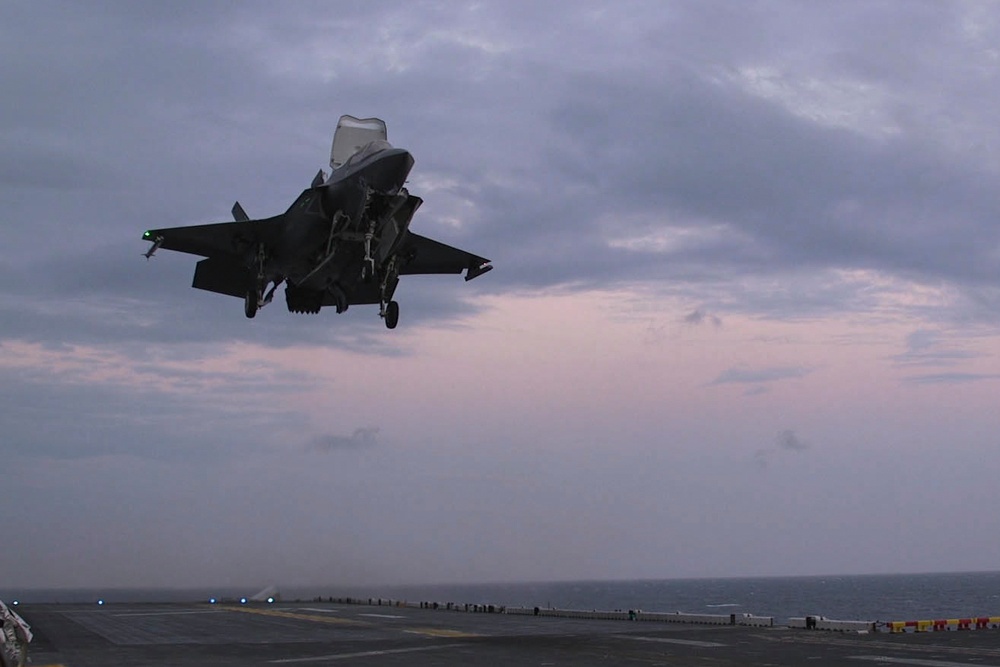 F-35B Lightning II fighters conduct flight operations at sea with external pylons