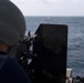 U.S. Navy Gunner’s Mate 2nd Class Brandon Diep, from Riverside, California, fires an M240B machine gun at an inflatable target