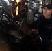 U.S. Navy Seaman Ofelia Velasquez, from West Palm Beach, Florida, stands watch as the helmsman aboard USS Spruance