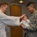 1st Lt. Michael Zimmer, chaplain performs the laying on of hands during the baptism ceremony