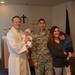 1st Lt. Michael Zimmer, chaplain and Capt. Phillip Tran, equal opportunity director and family celebrate the baptism of Jacob Tran