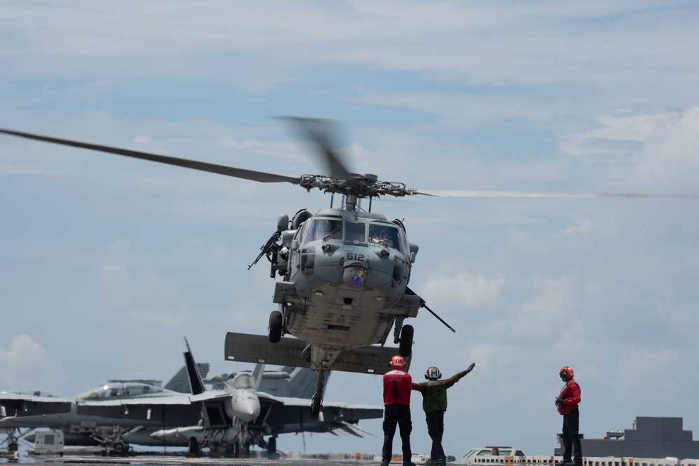 An MH-60S Sea Hawk lands on the flight deck