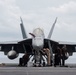 U.S. Sailors clean an F/A-18F Super Hornet