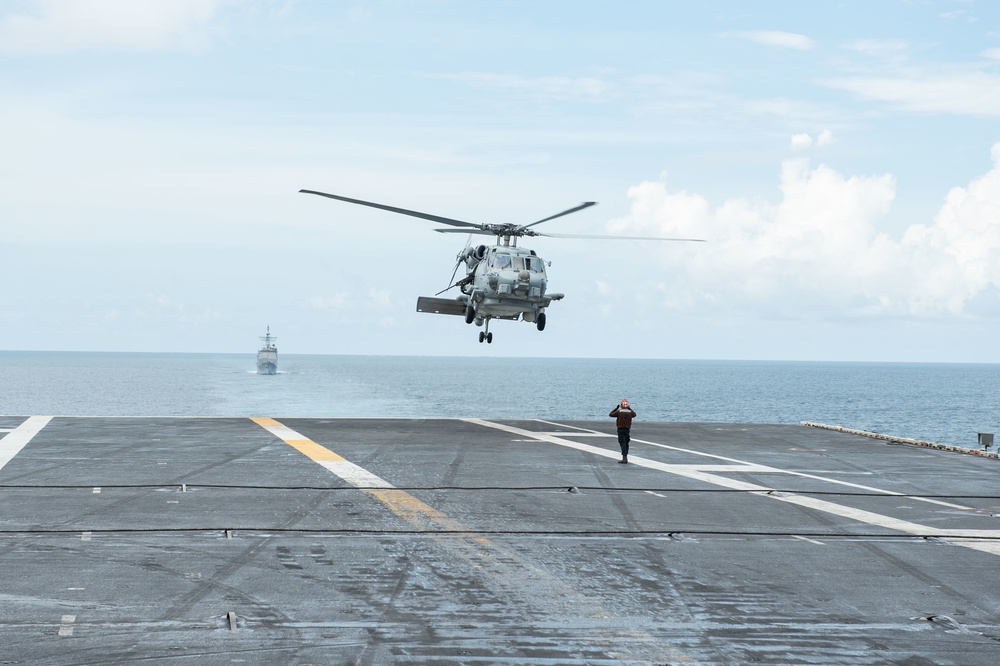 An MH-60R Sea Hawk prepares to land on the flight deck