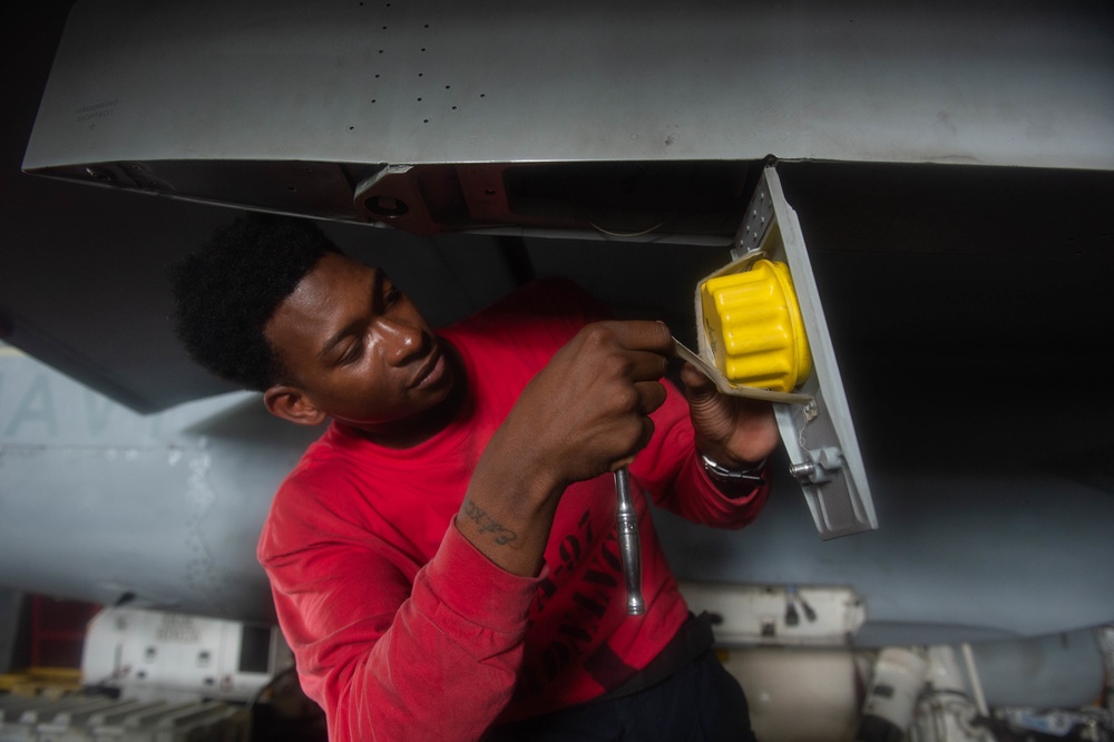 U.S. Sailor conducts maintenance