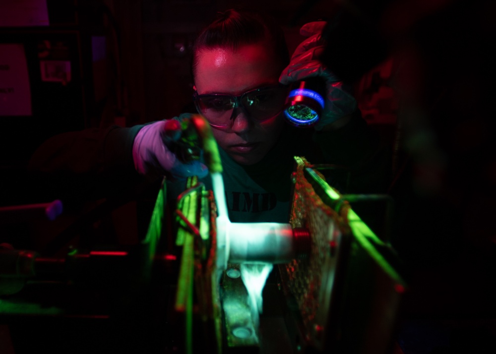 U.S. Sailor conducts a magnetic particle inspection