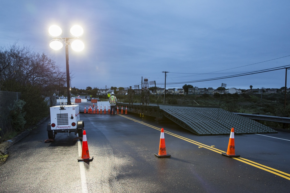 Building Bridges: U.S. Marines and contractors assess the safety and durability of a medium girder bridge