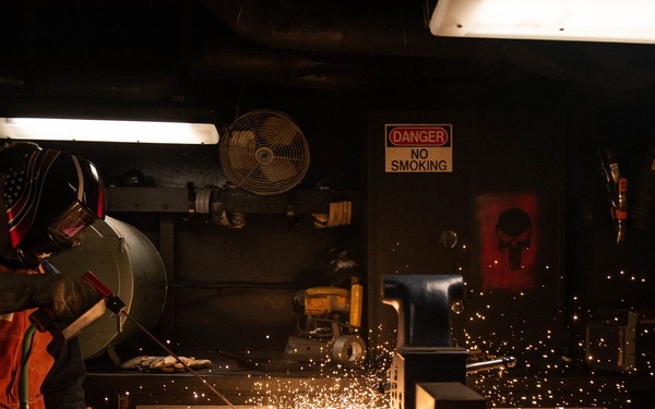 U.S. Sailor tests a portable exothermic cutting unit