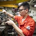Machinery Repairman 3rd Class Antoniojerome Pascual turns parts for a stern gate
