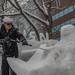 Sailor cleans snow sculpture