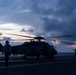 U.S. Sailors finish chocking an chaining an MH-60R Sea Hawk