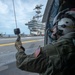 U.S. Sailor conducts pre-flight, check on an MH-60R Sea Hawk