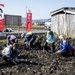 Learning the roots: station residents dig lotus roots