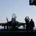 U.S. Sailor directs an an F/A-18E Super Hornet