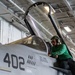U.S. Sailors conduct a check on an F/A-18E Super Hornet