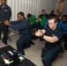 U.S. Sailors trains with an M9 pistol fitted for a Multiple Interactive Learning/Training Objectives Range