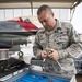 Weapons loaders teach student pilots