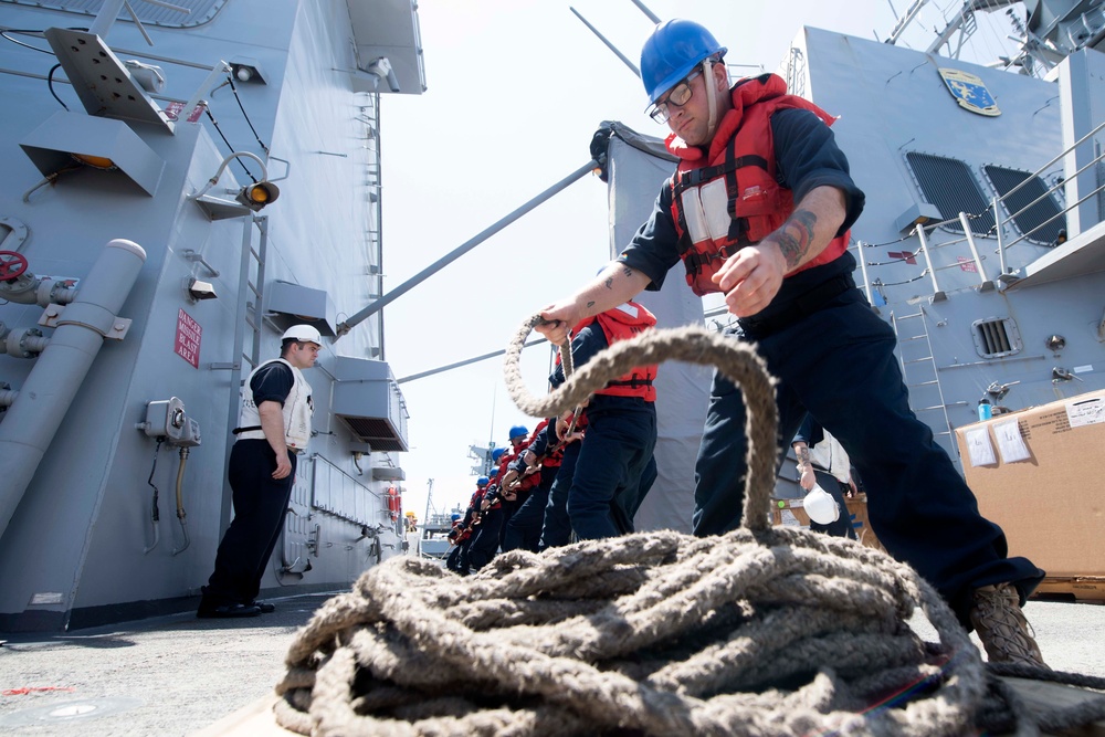 U.S. Navy Sailor handles line during a replenishment-at-sea.