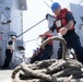 U.S. Navy Sailor handles line during a replenishment-at-sea.