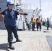 U.S. Navy Boatswain’s Mate heaves in line during a replenishment-at-sea
