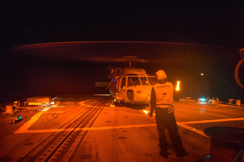 U.S. Sailor signals helicopter