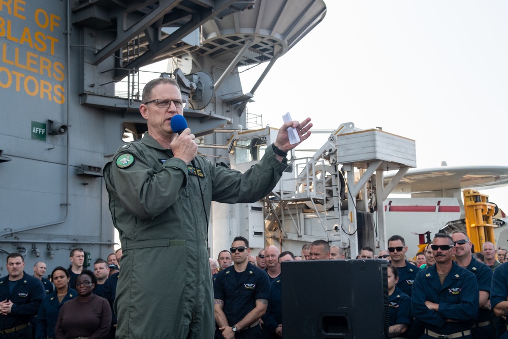 Commander, Carrier Strike Group (CSG) 3 addresses the crew during an all-hands call