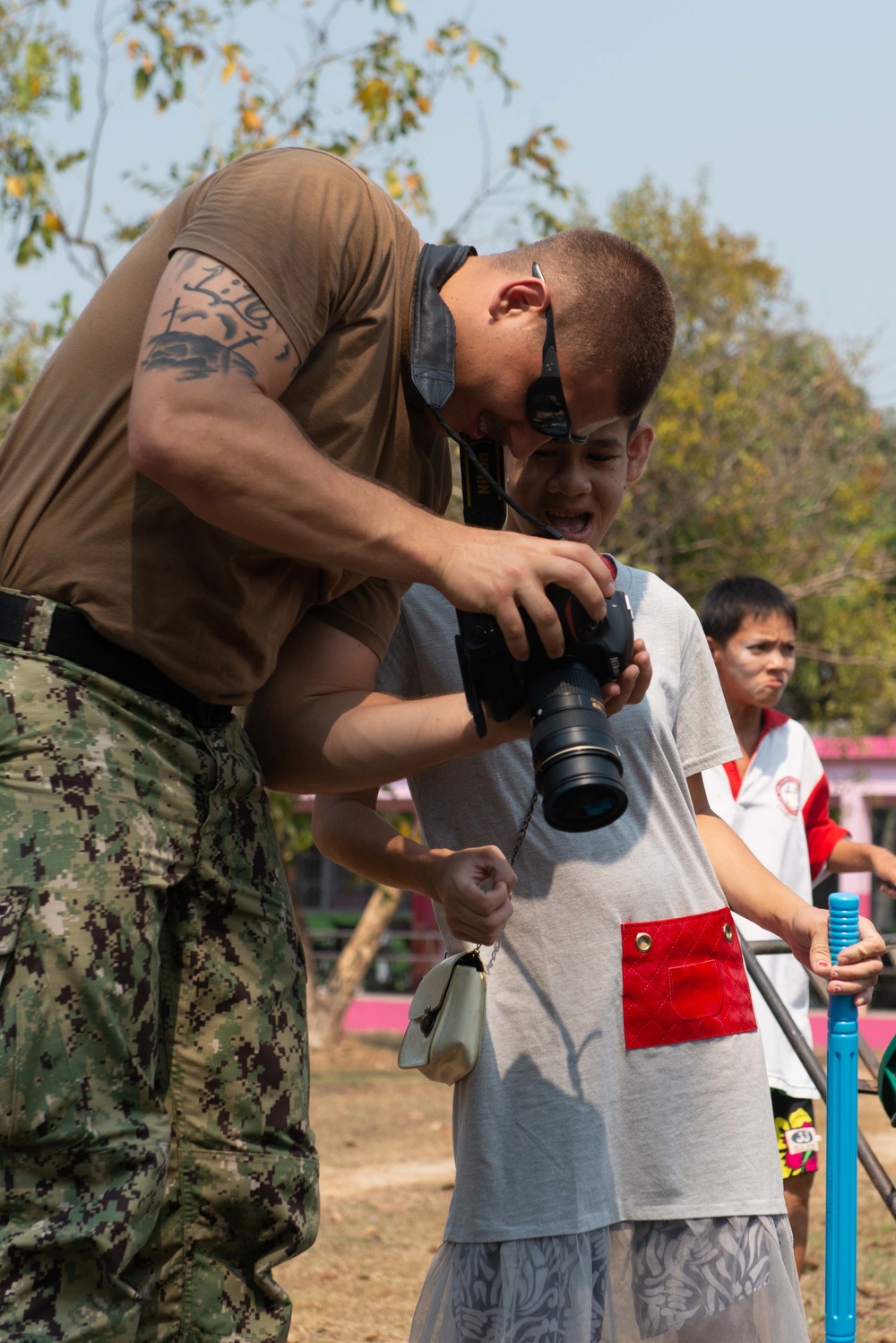 U.S. Sailors volunteer at the Kanunyawet Home for Disabilities in Pattaya, Thailand