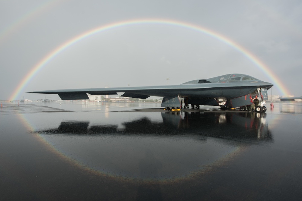 B-2 docked on flightline under rainbow in Hawaii