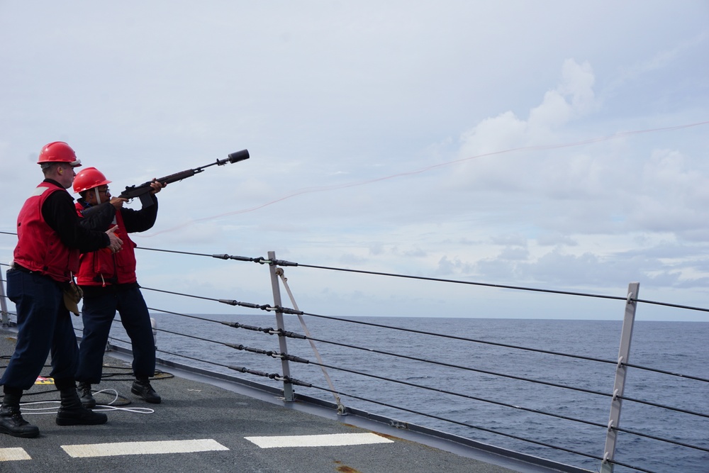 Gunner's Mates from USS WILLIAM P LAWRENCE shoot shotlines forward during a Replenishment At Sea (RAS)