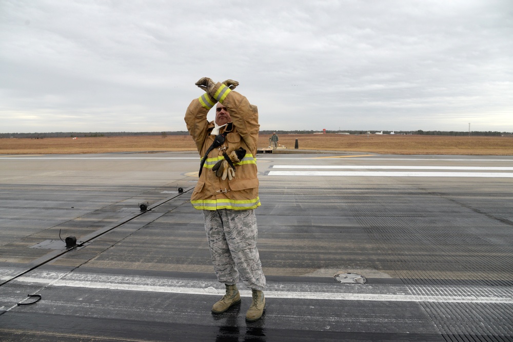 177th Fighter Wing pilots, firefighters, power production and civilian personnel perform active fighter aircraft cable arresting system test